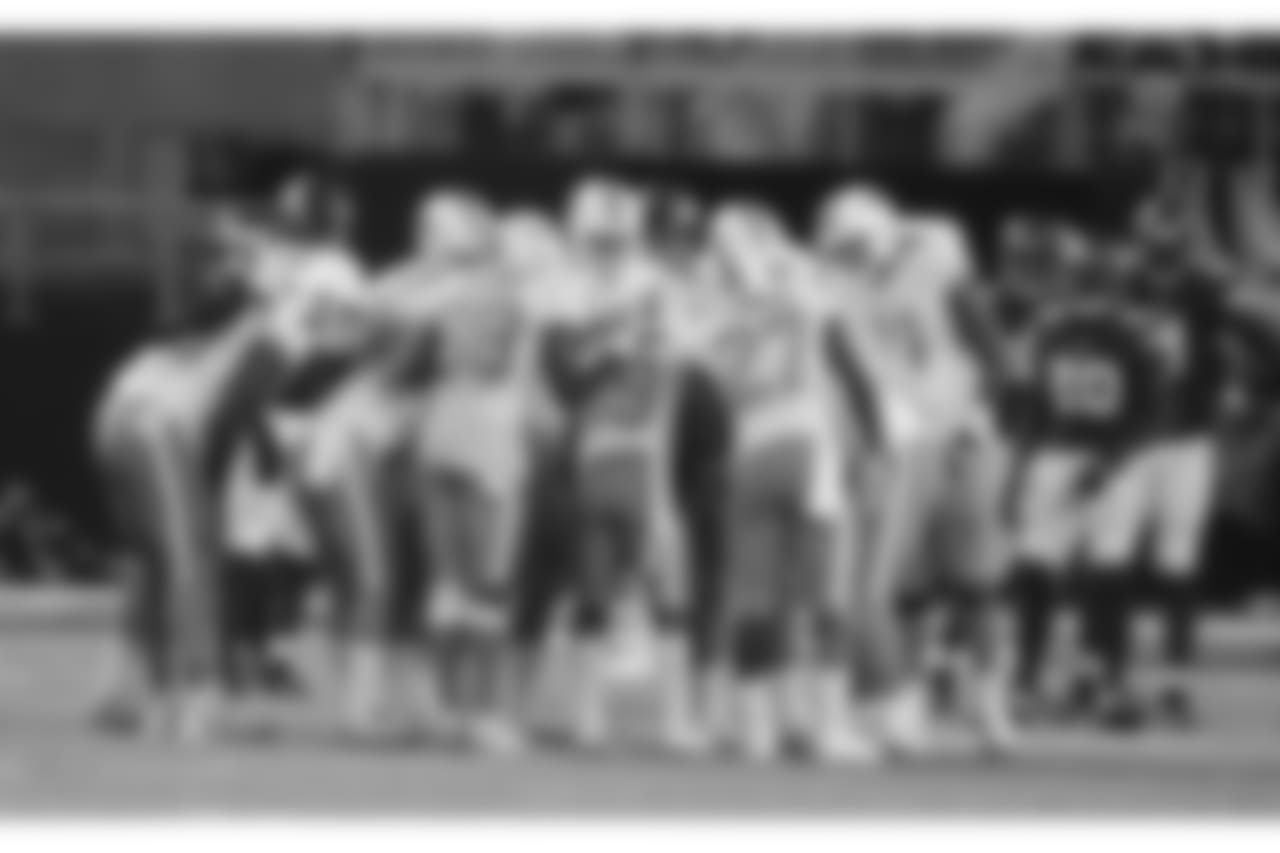 Miami Dolphins players stand in the huddle during the first half of an NFL preseason football game against the Minnesota Vikings, Thursday, Aug. 31, 2017, in Minneapolis. (AP Photo/Jim Mone)
