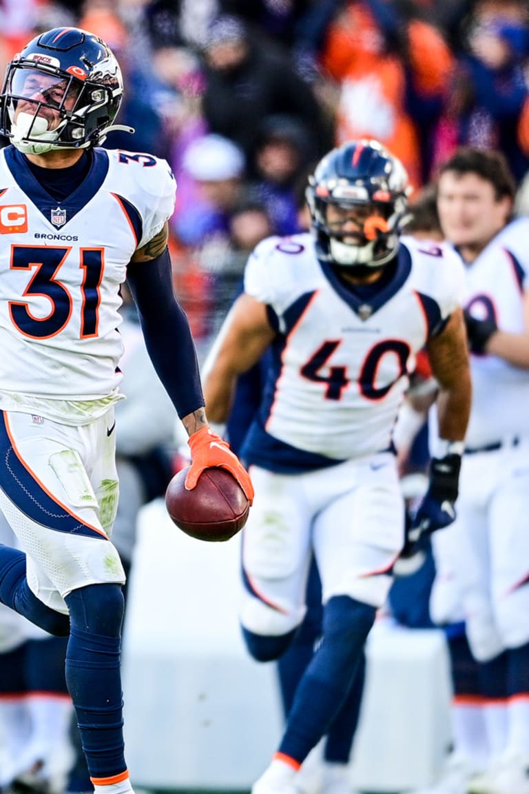 Justin Simmons and PJ Locke of the Denver Broncos run through