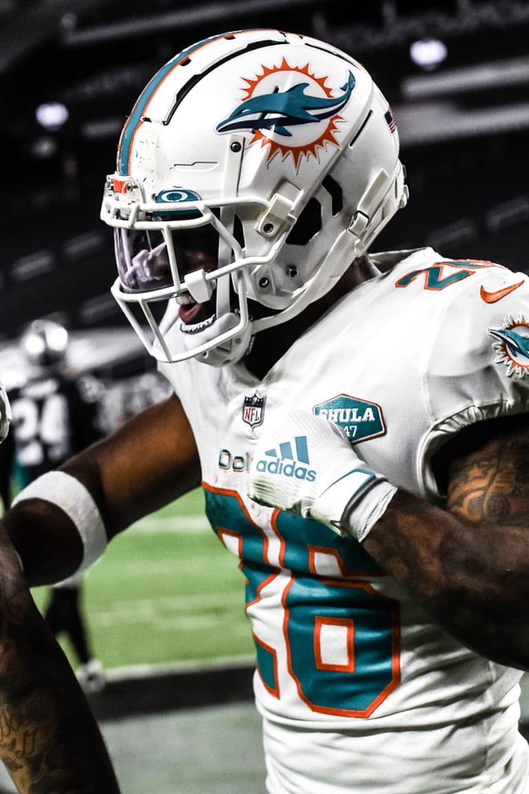 Miami Dolphins running back Salvon Ahmed (26) and running back Myles Gaskin  (37) watch from the sideline during the first half of a NFL preseason  football game Las Vegas Raiders, Saturday, Aug.