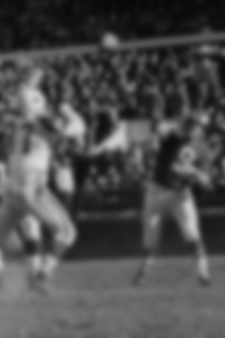 Quarterback Sonny Jurgensen (9) of the Philadelphia Eagles gets off first period pass to end Pete Retzlaff (not shown) good for nine yard gain and a first down in the game Eagles-Cowboys pro football game in Philadelphia, Nov. 26, 1961. Cowboys end Nate Borden (87) reaches in vain for ball in effort to break up play. Jurgensen threw five touchdown passes as the Eagles won over the Cowboys 35-13. (AP Photo/Sam Myers)