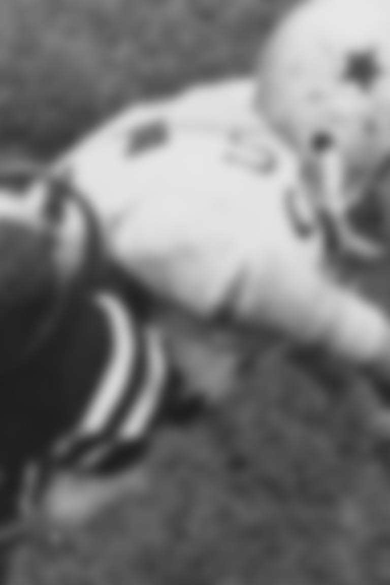 Quarterback Sonny Jurgensen (9) of the Philadelphia Eagles gets off first period pass to end Pete Retzlaff (not shown) good for nine yard gain and a first down in the game Eagles-Cowboys pro football game in Philadelphia, Nov. 26, 1961. Cowboys end Nate Borden (87) reaches in vain for ball in effort to break up play. Jurgensen threw five touchdown passes as the Eagles won over the Cowboys 35-13. (AP Photo/Sam Myers)