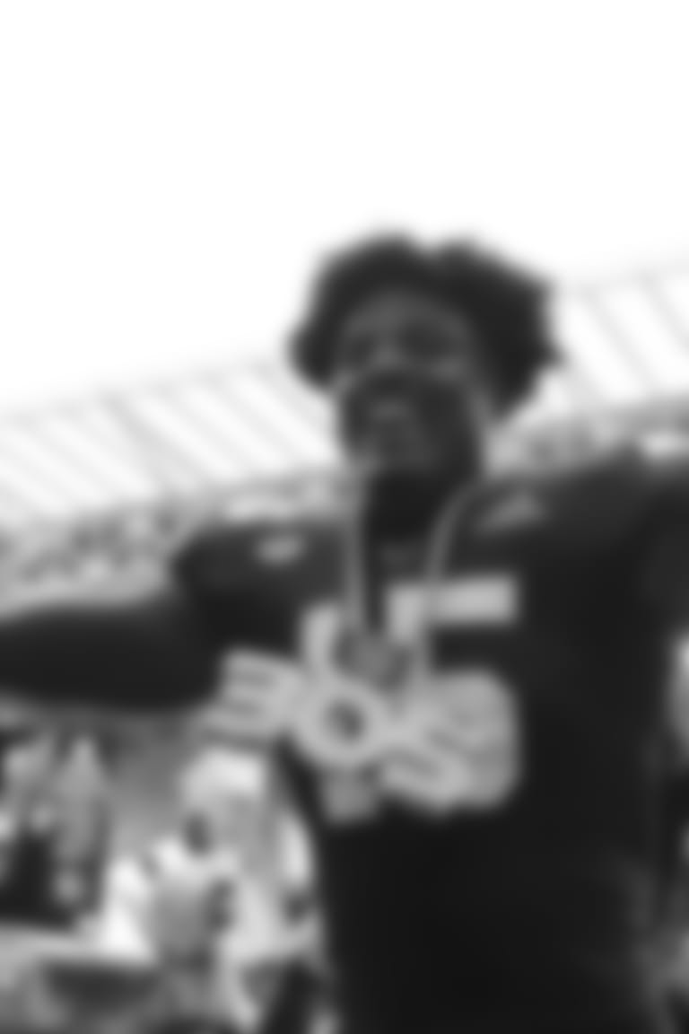 FILE - In this Sept. 21, 2019, file photo, Miami defensive lineman Gregory Rousseau (15) celebrates a turnover and wears the turnover chain during the first half of an NCAA college football game against Central Michigan, in Miami Gardens, Fla. Rousseau was selected to The Associated Press All-Atlantic Coast Conference football team, Tuesday, Dec. 10, 2019. (AP Photo/Brynn Anderson, File)