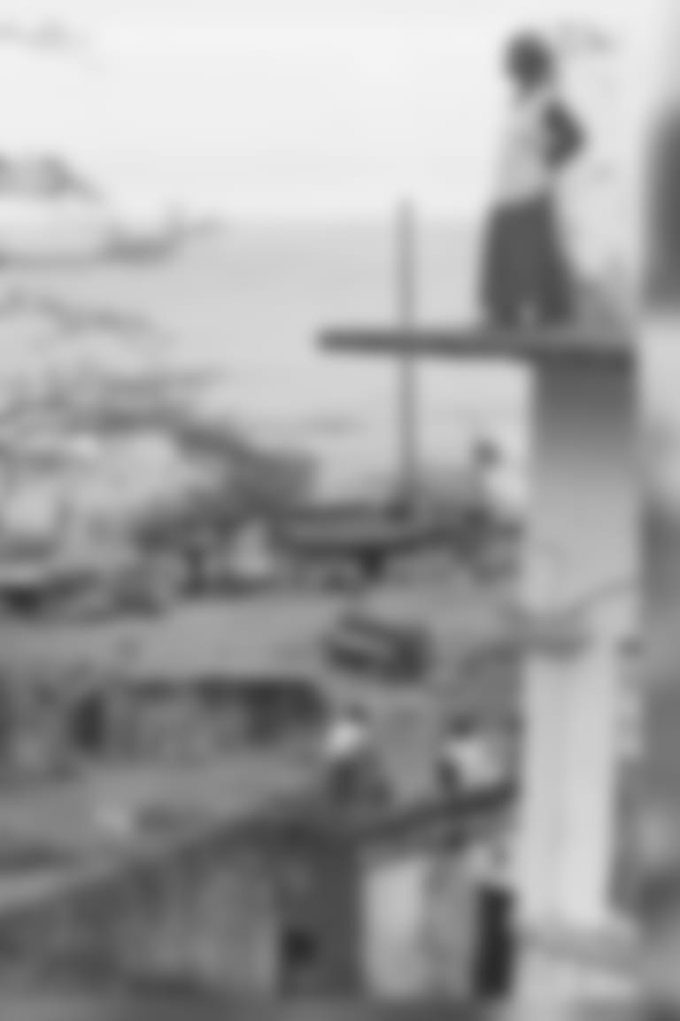 A Liberian woman Tuesday February 3, 1998 stands on the ledge of what used to be a hospital in Monrovia where she and about 200 other displaced people have been living since the civil war began seven years ago. The newly elected government of Liberia has said that all squatters living in the many public buildings in the capital city must move out now that the war has ended. (AP Photo/David Guttenfelder)