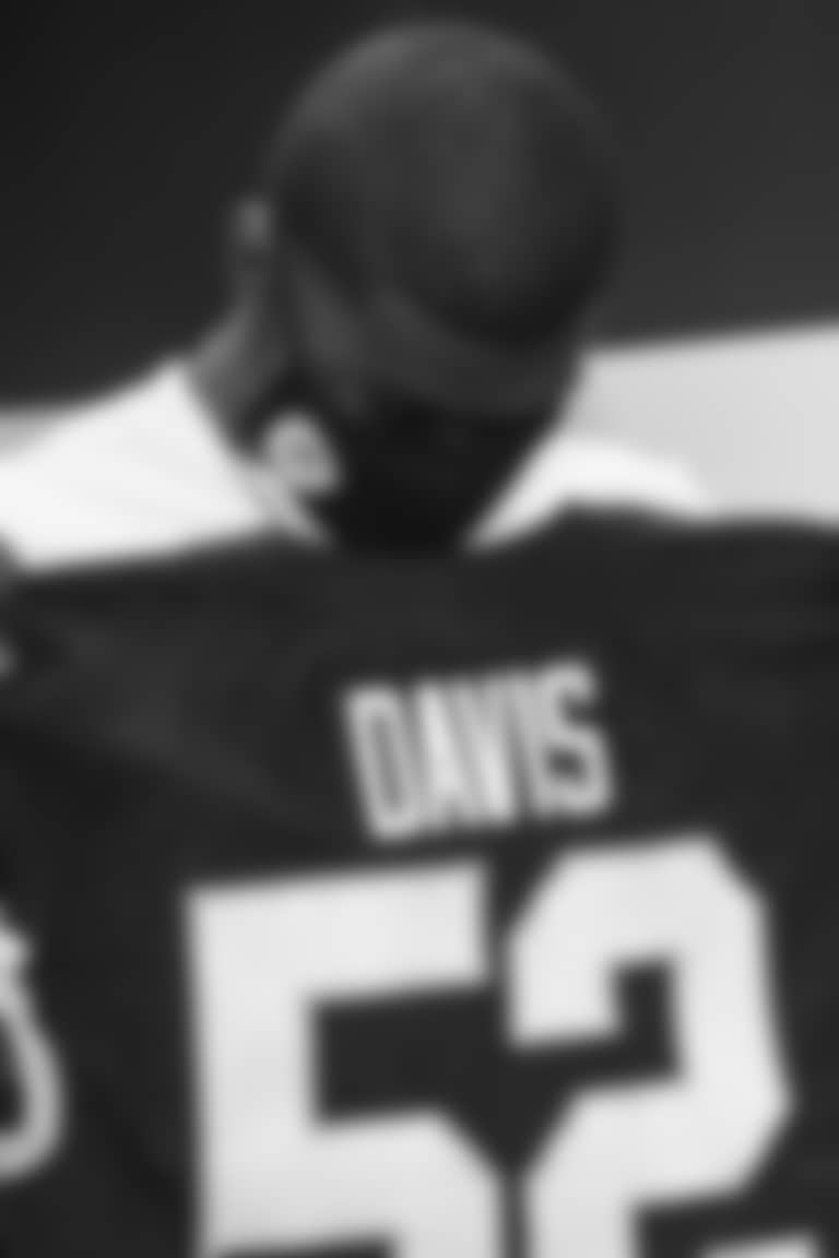 Washington Football Team first-round pick Jamin Davis takes a look at his new jersey during a visit to Inova Sports Performance Center. (Emilee Fails/Washington Football Team)