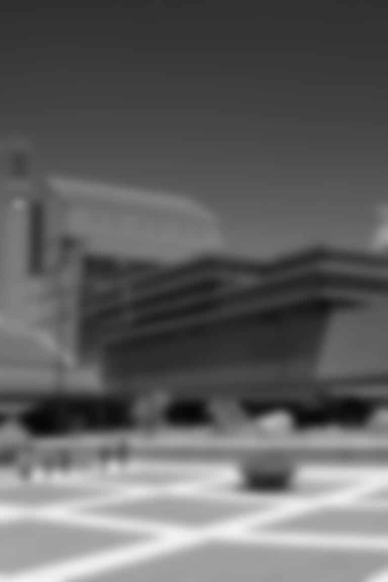 View of the courtyard of the British Library, London, with the gothic towers of St Pancras Station peeping over the top at the right.