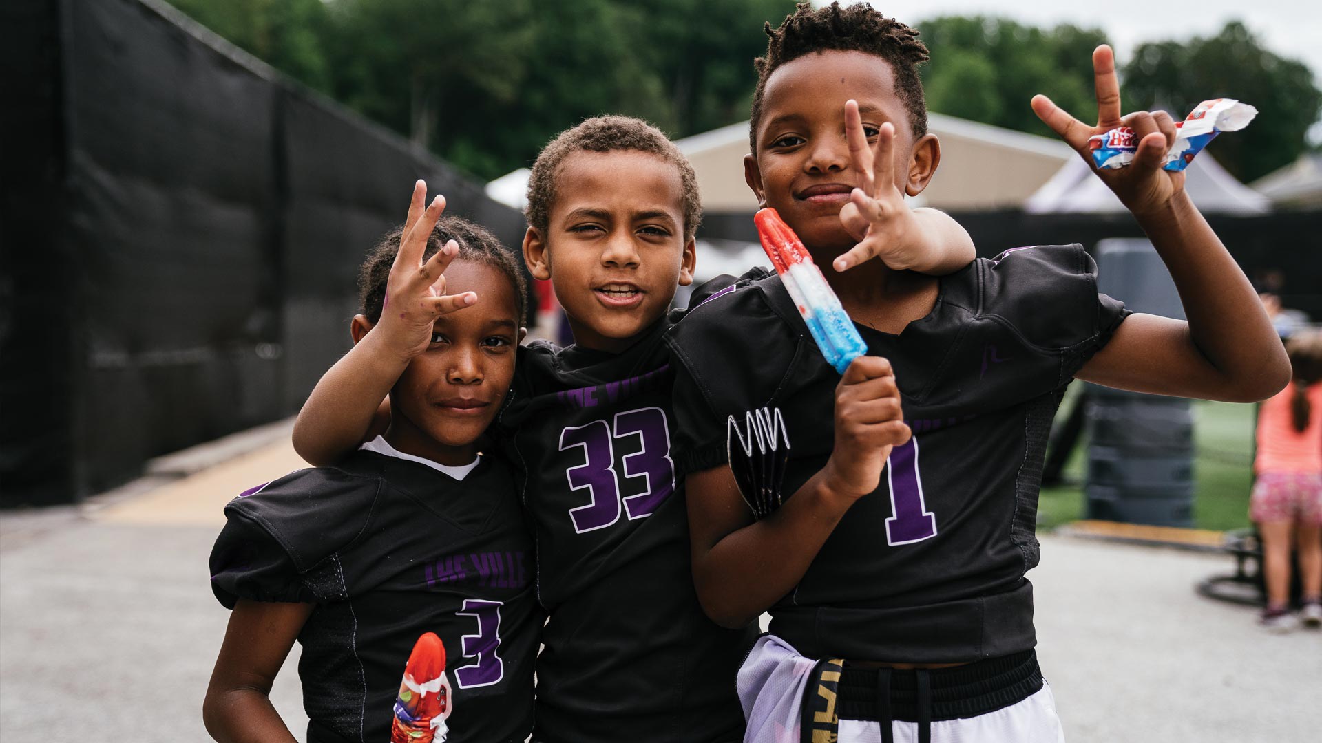 Teammates from a local youth football club pose at Ravens Training Camp.