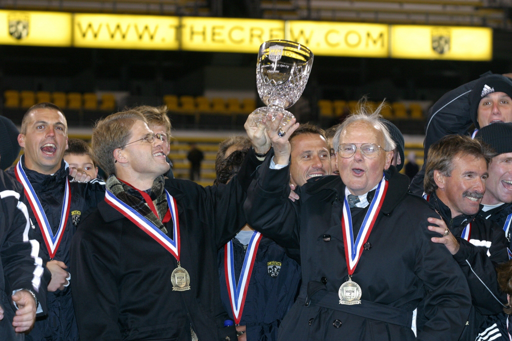 Lamar and Clark Hunt photographed with the Lamar Hunt U.S. Open Cup trophy in 2002