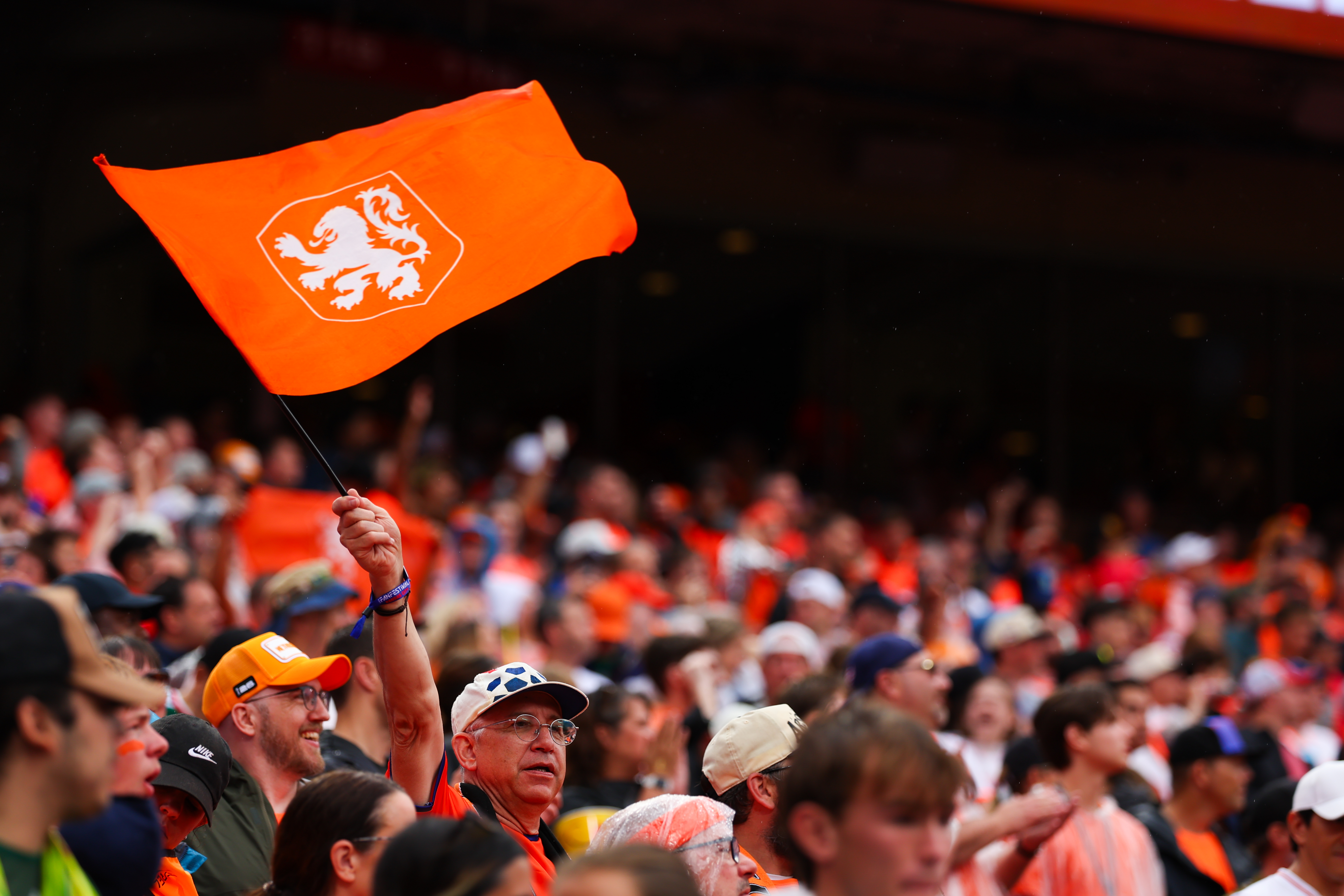 A Netherlands fan waves a flag in the crowd