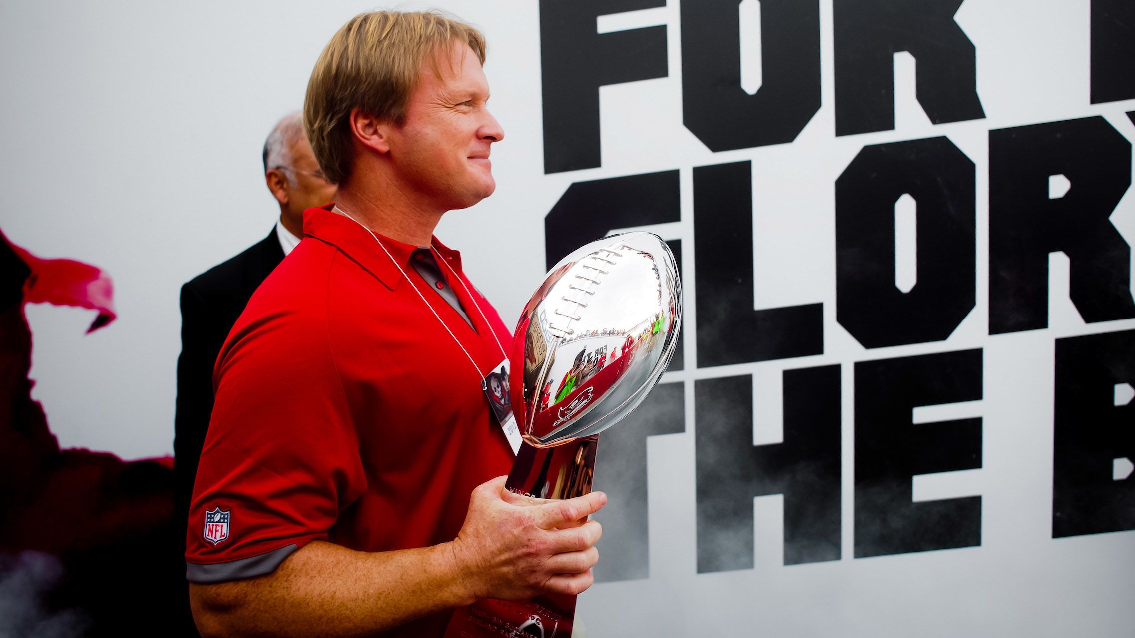 TAMPA, FL - DECEMBER 9: Tampa Bay Buccaneers former head coach John Gruden walks with the Lombardo Trophy during the game against the Philadelphia Eagles at Raymond James Stadium on December 9, 2012, in Tampa, Florida. The Buccaneers lost 23-21. (photo by Chip Litherland/Tampa Bay Buccaneers)