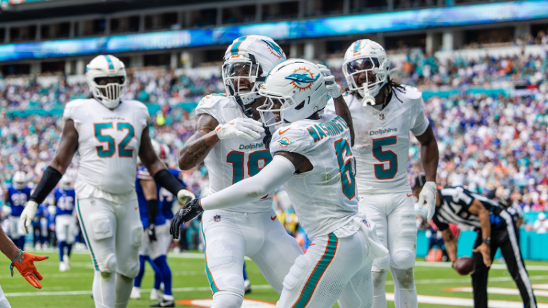 Photo of Dolphins players sitting in the endzone.