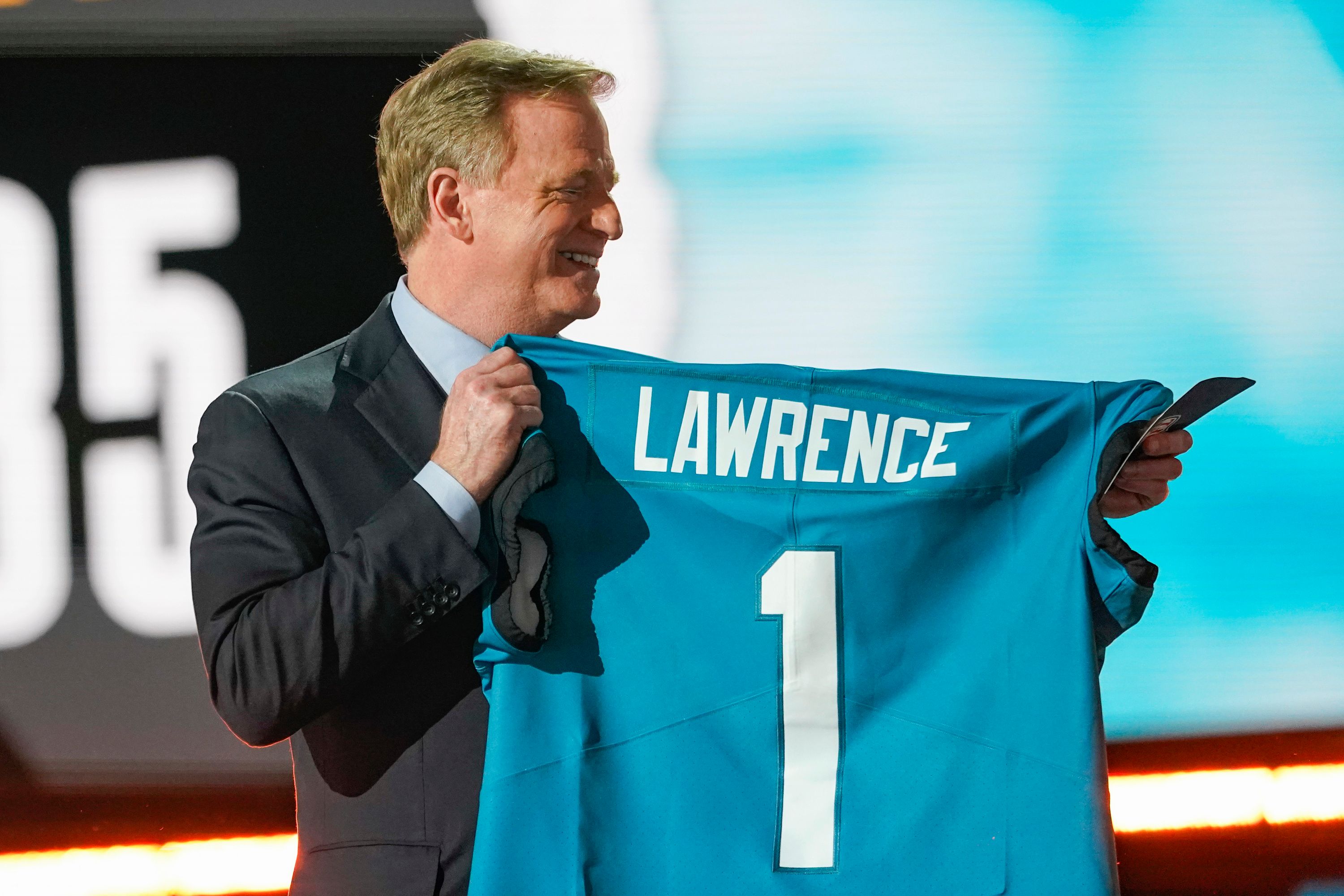 NFL Commissioner Roger Goodell holds a Jacksonville Jaguars jersey as he announces that the Jaguars had chosen Clemson quarterback Trevor Lawrence with the first pick in the NFL football draft, Thursday April 29, 2021, in Cleveland. (AP Photo/Tony Dejak)