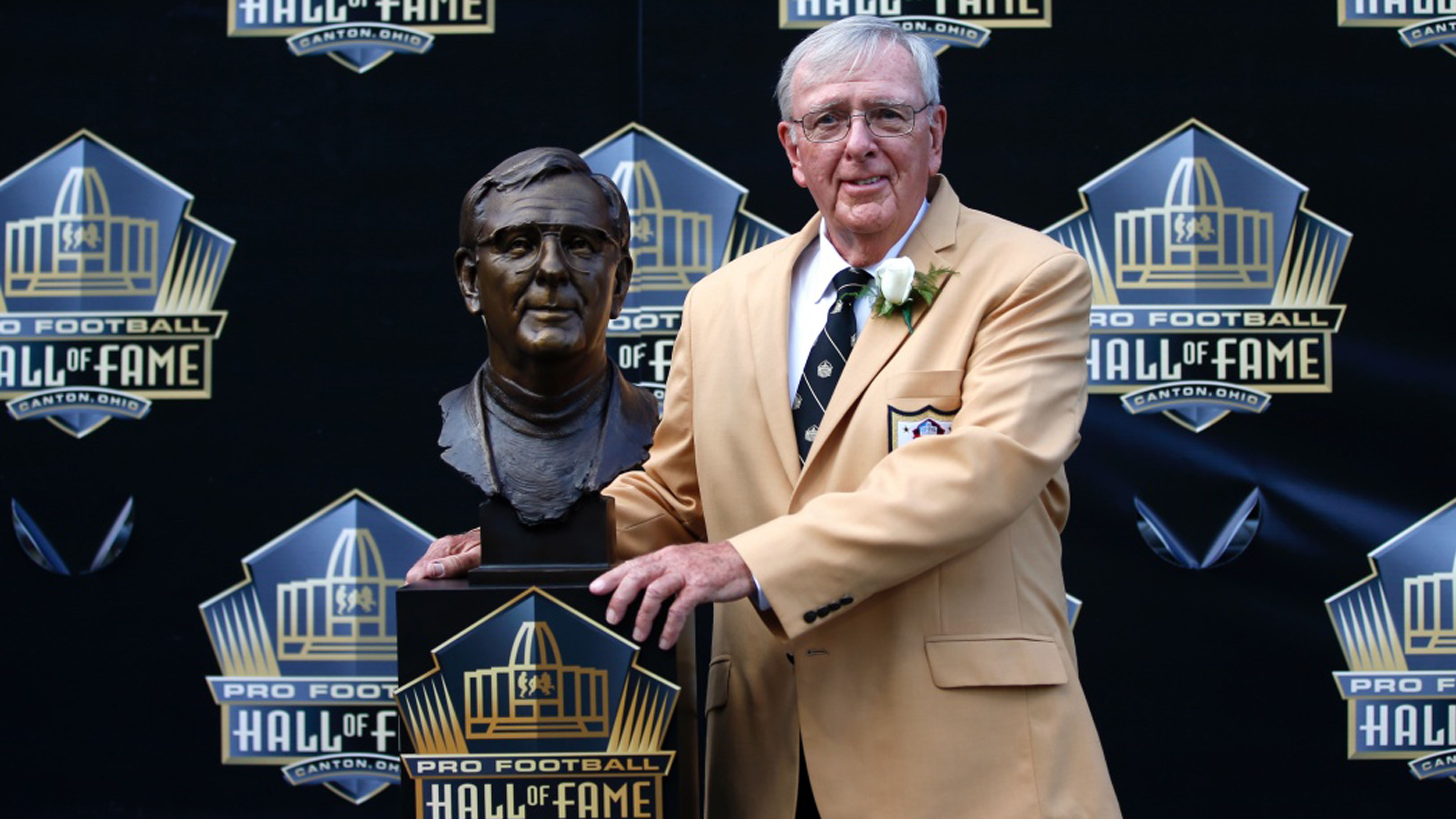 Former NFL Contributor Ron Wolf poses with a bust of himself during an induction ceremony at the Pro Football Hall of Fame Saturday, Aug. 8, 2015, in Canton, Ohio.  (AP Photo/Gene J. Puskar)