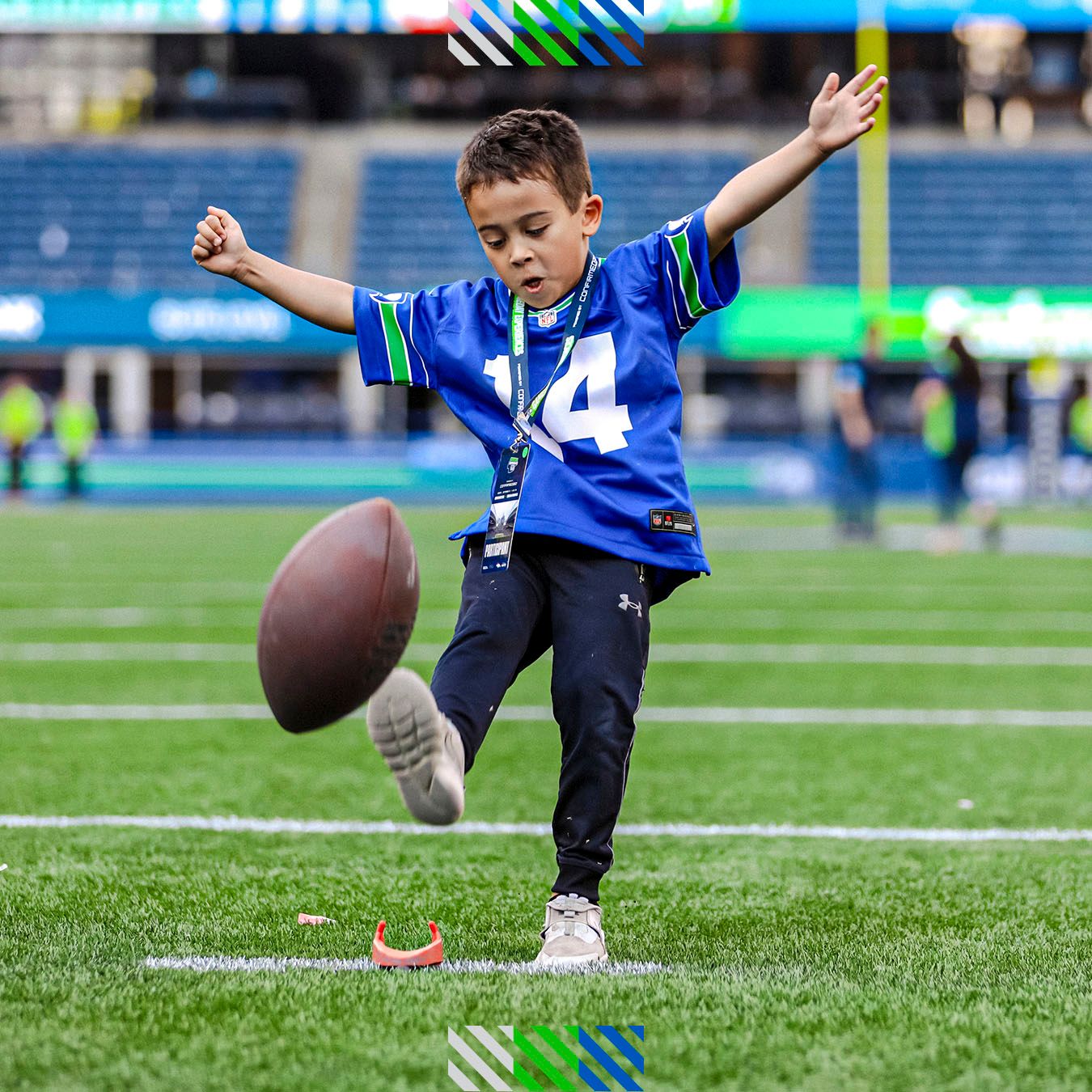 A boy kicking a football on the field