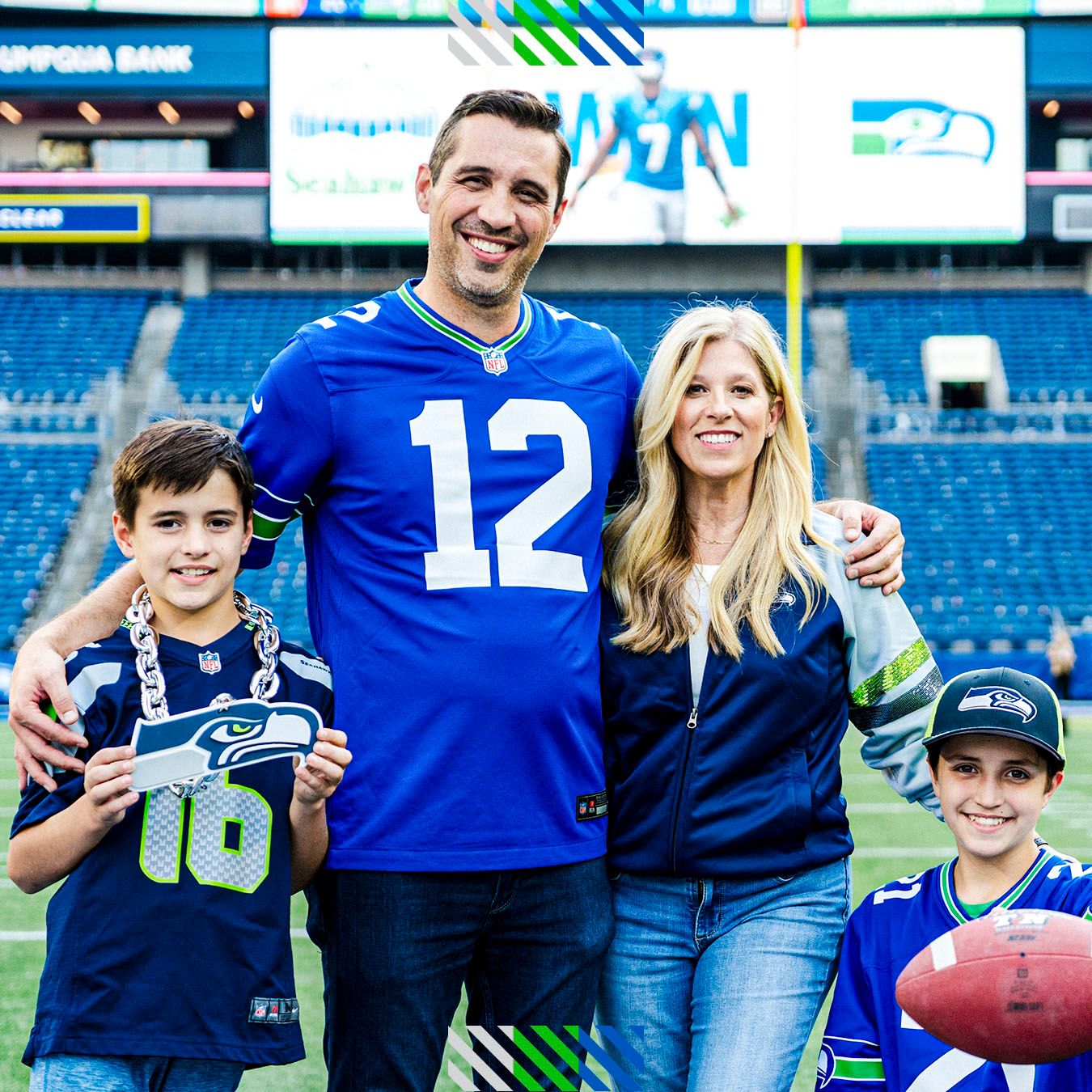 A group of fans posing for a photo on the field