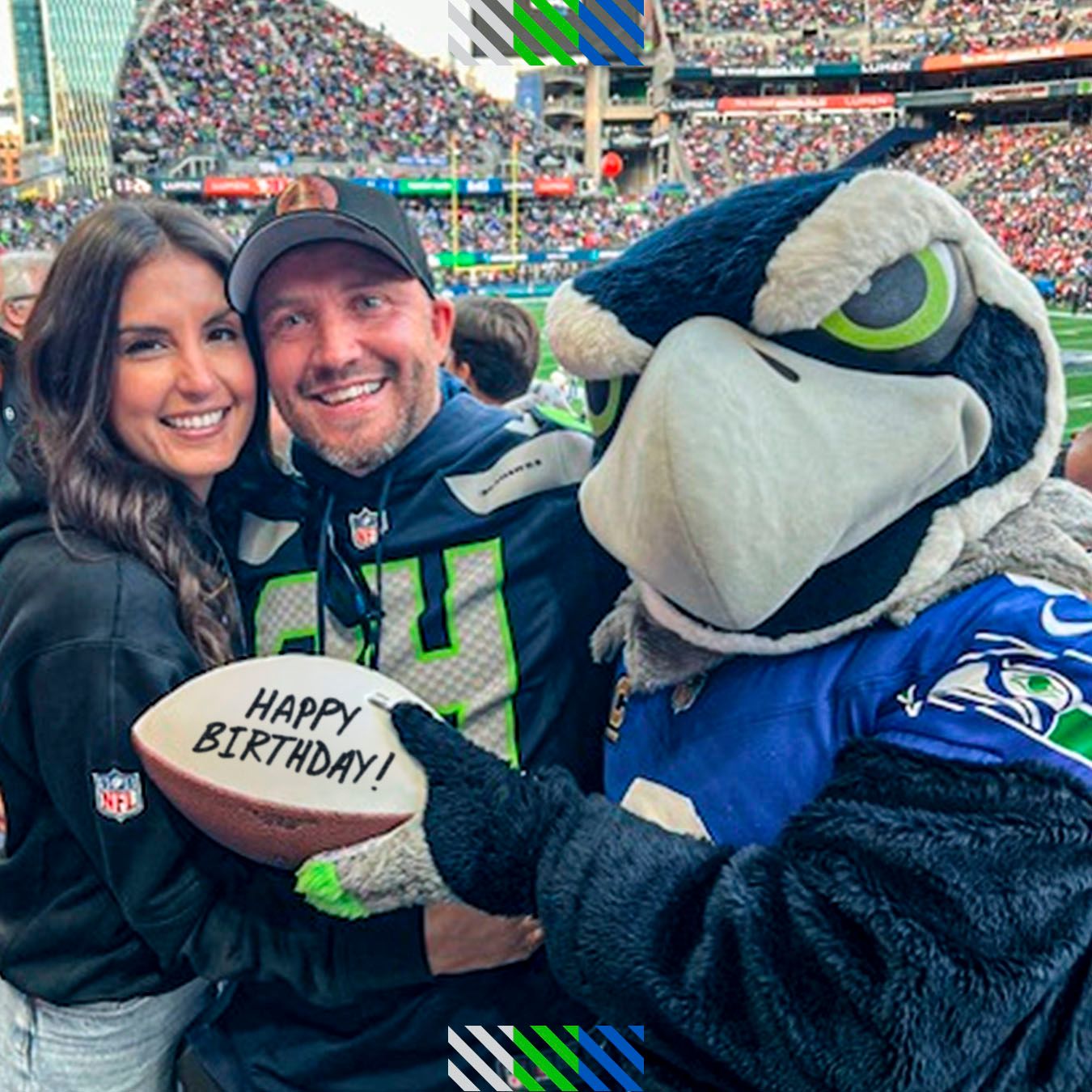 Blitz handing a custom football to a fan