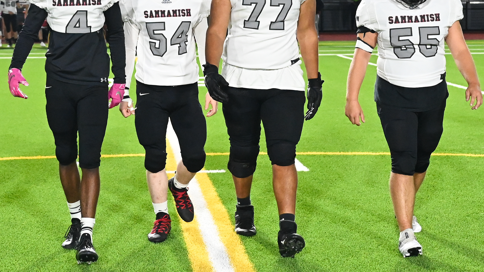 High School football players walking across a field