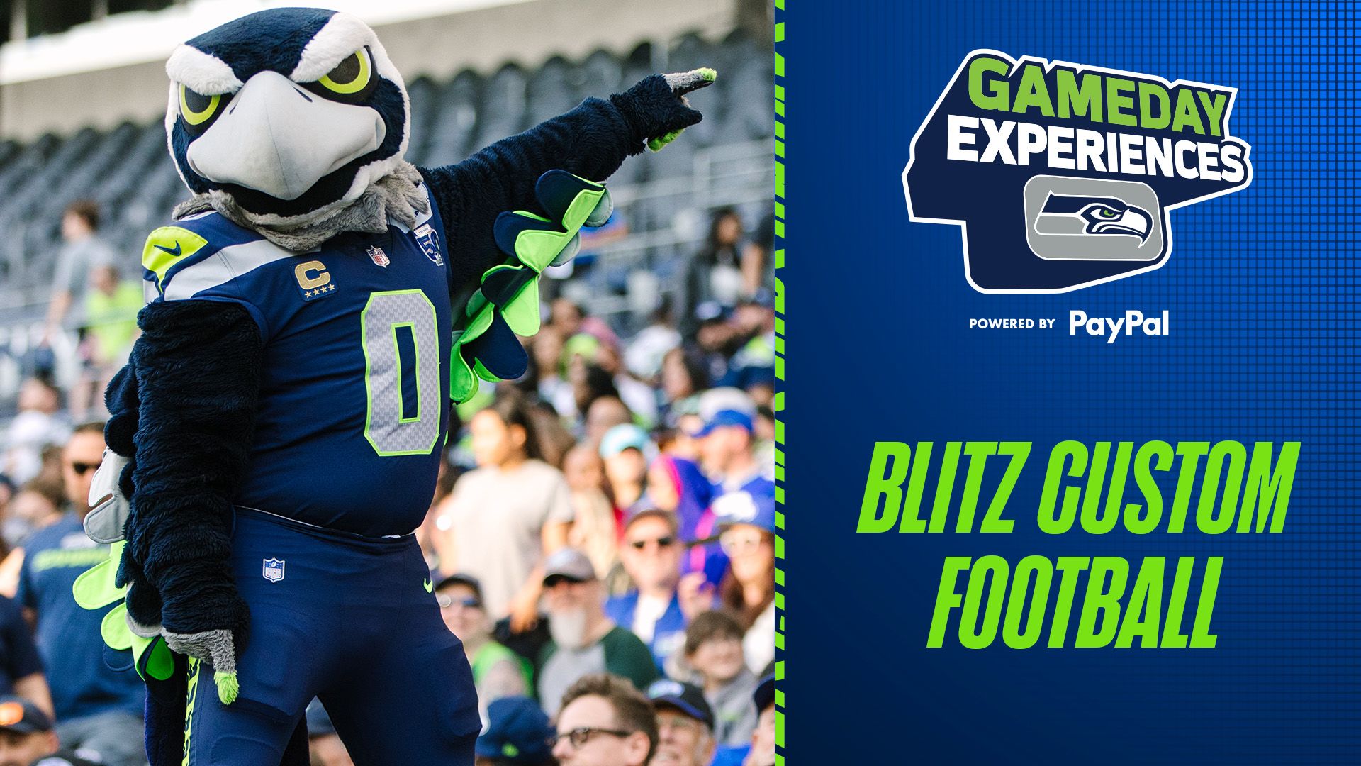 Blitz handing a custom football to a fan