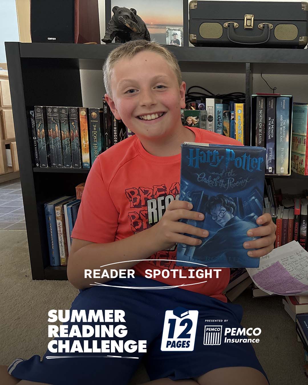 A photo of Elliot reading - Reader Spotlight - Summer Reading Challenge