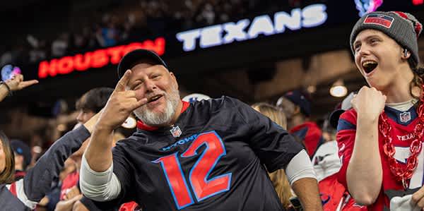 Texans fans celebrating in the stands.