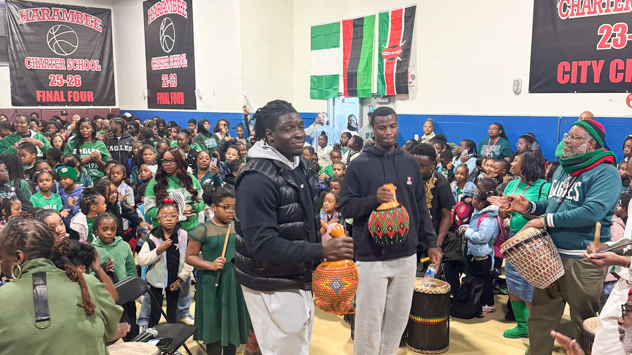 Eagles rookies Uar Bernard and Joshua Weru visiting students at Harambee Institute