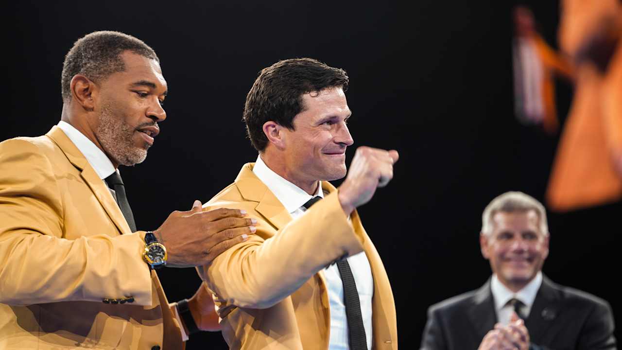 Luke Kuechly gets his gold jacket from Julius Peppers, bringing it full circle