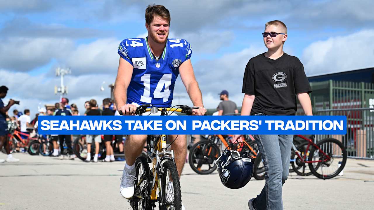 Seahawks Players Ride Bikes On Their Way To A Joint Practice With The Packers