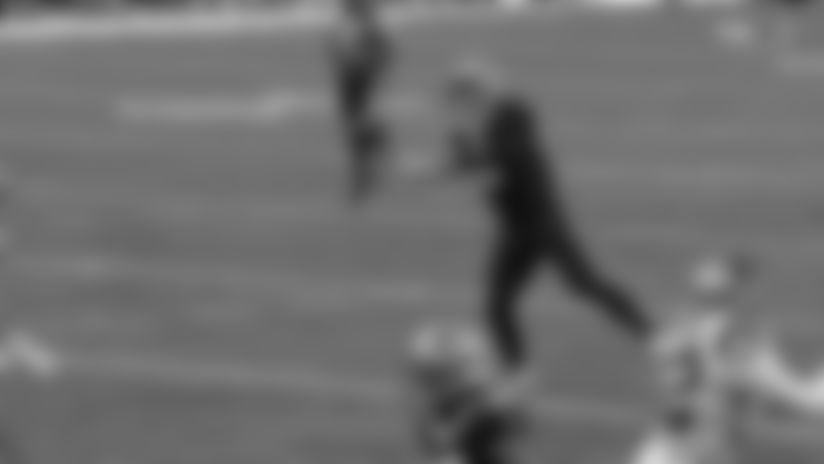 New Orleans Saints quarterback quarterback Tyler Shough rolls to his left and rips a nifty side-arm pass to wide receiver Devaughn Vele for an 11-yard gain against the Carolina Panthers.