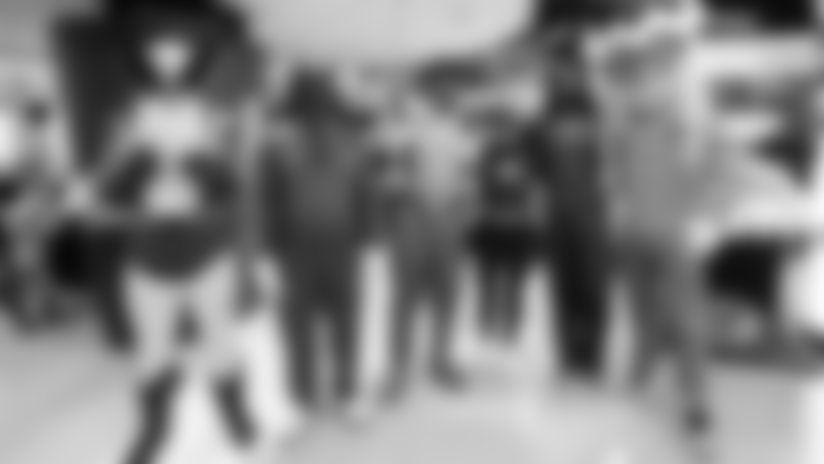 View photos of FB C.J. Ham, his wife Stephanie, and Vikings running backs Ty Chandler, Corey Kiner, and Zavier Scott dressed in costumes at the Children's Minnesota St. Paul campus for reverse Trick-or-Treating.