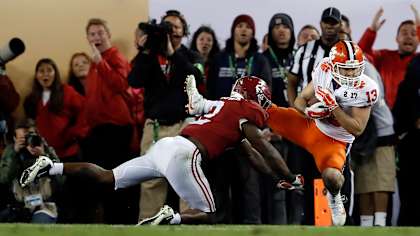 FILE- In this Jan. 10, 2017, file photo, Clemson's Hunter Renfrow, right, catches a touchdown pass in front of Alabama's Tony Brown during the second half of the NCAA college football playoff championship game in Tampa, Fla. Renfrow, a former walk-on, made the catch with 1 second left that gave Clemson a win over Alabama in the College Football Playoff championship game.