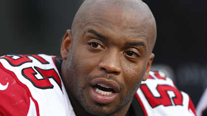 In this Dec. 9, 2012 file photo, Atlanta Falcons defensive end John Abraham is shown on the sidelines during the second half of the NFL football game against the Carolina Panthers in Charlotte, N.C.