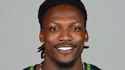 Riq Woolen in Seattle Seahawks uniform breaking up pass