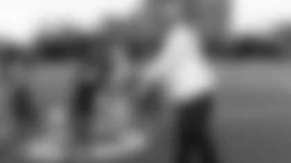 Principal Rickey Harris congratulates senior Brithany Torres on Senior Night.