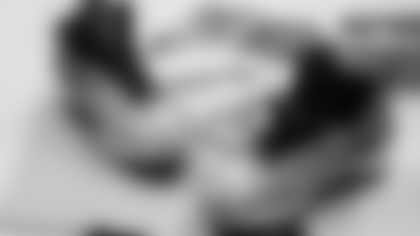 Scout Rooney works on painting the My Cause My Cleats for Arizona Cardinals offensive lineman Kelvin Beachum (68) on Thursday, Nov 7, 2024 in Mesa, AZ.