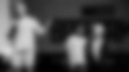 Kurt Warner speaks to the crowd prior to the start of Saturday's Cardinals Climb with his special needs son Zack and wife Brenda in the background.