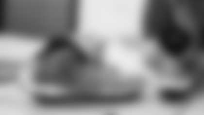 Scout Rooney works on painting the My Cause My Cleats for Arizona Cardinals offensive lineman Kelvin Beachum (68) on Thursday, Nov 7, 2024 in Mesa, AZ.