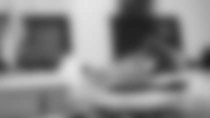 Scout Rooney works on painting the My Cause My Cleats for Arizona Cardinals offensive lineman Kelvin Beachum (68) on Thursday, Nov 7, 2024 in Mesa, AZ.