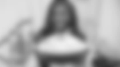 Krystal holds a football commemorating her 100th game as a Chiefs Cheerleader