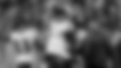 Baltimore Ravens quarterback Joe Flacco (5) congratulates wide receiver Lee Evans (83) in the first half of an NFL football game, Sunday, Jan. 1, 2012, in Cincinnati. Baltimore Ravens head coach John Harbaugh is at right. (AP Photo/Darron Cummings)