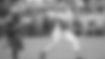 Cleveland Browns quarterback Shedeur Sanders (12) runs against Los Angeles Rams linebacker Jamil Muhammad (45) in the second half of an NFL preseason football game Saturday, Aug. 23, 2025, in Cleveland. (AP Photo/David Richard)