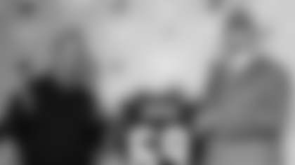 Carolina Panthers first round draft pick offensive tackle Jordan Gross from Utah holds his jersey with head coach John Fox as they face reporters, Sunday, April 27, 2003 in Charlotte, N.C. (AP Photo/Rick Havner)