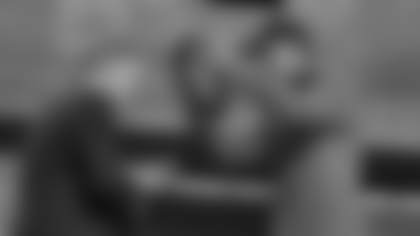 Arizona wide receiver Tetairoa McMillan, right, celebrates with NFL Commissioner Roger Goodell after being chosen by the Carolina Panthers with the eighth overall pick during the first round of the NFL football draft, Thursday, April 24, 2025, in Green Bay, Wis. (AP Photo/Jeff Roberson)