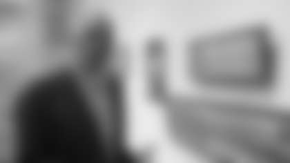 FILE - In this Jan. 11, 2018 photo, Alan Page, NFL Hall of Famer and retired Minnesota Supreme Court justice, stands in Minneapolis, by a photo of black babies labeled "Alligator Bait."  Page has counted art collection among his many life pursuits, and the former Vikings star has two of his prized pieces up for sale through a New York auction house, each valued at more than $200,000. (AP Photo/Steve Karnowski, File)