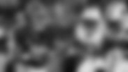 Alabama quarterback Bryce Young, left, scrambles away from Auburn defensive end Marcus Bragg (98) during the first half of an NCAA college football game Saturday, Nov. 26, 2022, in Tuscaloosa, Ala. (AP Photo/Butch Dill)