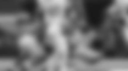 Texas quarterback Quinn Ewers, middle, runs against Ohio State safety Caleb Downs, left, and safety Sonny Styles (6) during the first half of the Cotton Bowl College Football Playoff semifinal game, Friday, Jan. 10, 2025, in Arlington, Texas. (AP Photo/Julio Cortez)