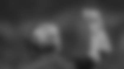 A sideline time official wearing an orange glove signals to the officials during a time out in an NFL football game between the Tampa Bay Buccaneers and Indianapolis Colts Sunday, Nov. 26, 2023 in Indianapolis. The Colt defeated the Buccaneers 27-20. (G. Newman Lowrance via AP)