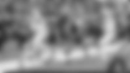 Los Angeles Rams tight end Colby Parkinson jumps over Arizona Cardinals' defense for a 21-yard touchdown at SoFi Stadium.