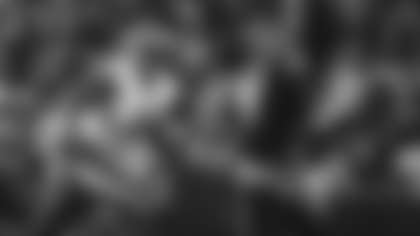 The Los Angeles Rams' defensive line sacks Seattle Seahawks quarterback Sam Darnold to force a fourth down at Lumen Field during their NFC Championship matchup.