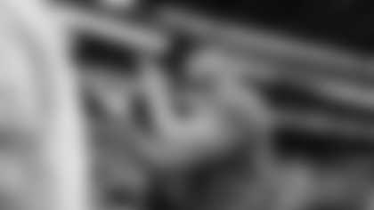 Head coach Mike Macdonald acknowledges the 12s as he walks off the field after the victory.