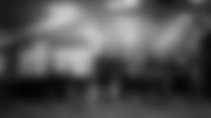 Seahawks players and coaches gather in prayer before taking the field.