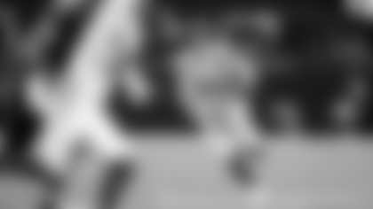 Seahawks quarterback Sam Darnold runs for extra yardage.